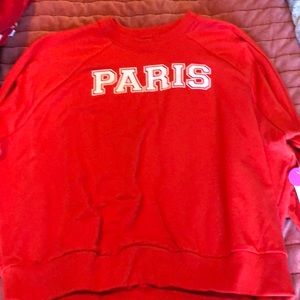 Red sweatshirt that says Paris on it.